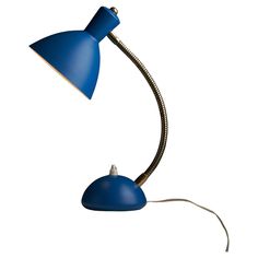 a blue desk lamp on a white background with a cord attached to the light fixture