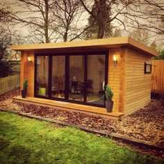 a small wooden cabin with sliding glass doors