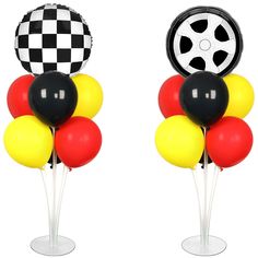 two black, white and red balloons are on top of each other in front of a checkered tire