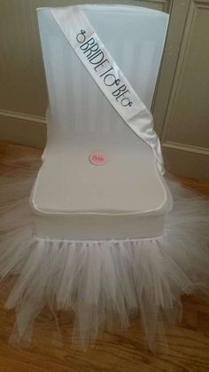 a white chair with tulle on top and a sash around the seat that says sweet chair