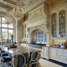 an ornate kitchen with marble counter tops and blue chairs