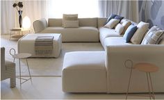 a living room filled with lots of white furniture