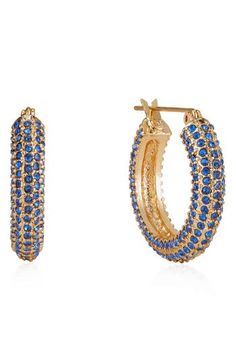 Pavé stones putt a sparkling twist on these rounded hoop earrings plated in gleaming 18-karat gold. 1" hoop diameter; 1/4" width Snap-post closure 18k-gold plate/glass Imported Small Hoop Earrings In Yellow Gold With Sparkling Stones, Gold Plated Hoop Earrings With Sparkling Stones, Blue Gold-plated Hoop Earrings, Glamorous Gold Plated Yellow Gold Hoop Earrings, Blue Tarnish Resistant Hoop Earrings, Blue Tarnish-resistant Hoop Earrings, Glamorous Small Hoop Earrings As Gift, Sza Concert, Earring Stacks