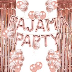 some pink and silver balloons are in front of a party banner with the words pajama party on it