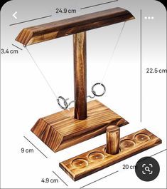 a wooden stand with two rings on it and measurements for each item in front of it