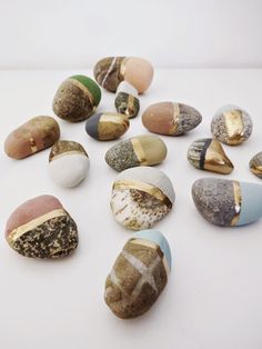 several different types of rocks on a white surface