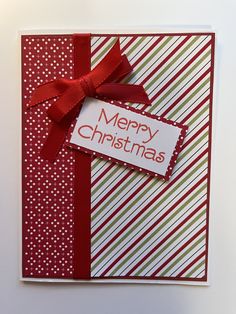 a christmas card with a red ribbon on it