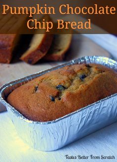 there is a loaf of pumpkin chocolate chip bread in the pan on the table next to it