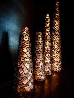 three bottle caps sitting on top of a wooden table next to each other in front of a black wall