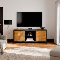 a living room with a large flat screen tv on top of a wooden entertainment center