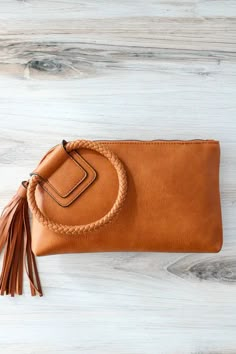 This Kayla Tassel Wristlet Clutch is the perfect accessory to bring a little fun to any outfit. It'll add a splash of color and swing to your style, so you can look and feel fabulous. Interior front: bill slot & 6 credit card slots; interior back: zip pocket Fits your smartphone Solid leather wristlet strap 10" w x 6" h x 0.5" d Silver Clutch Purse, Studded Sandals, Wristlet Clutch, Leather Projects, Crossbody Wallet, Leather Bags Handmade, Leather Diy, Leather Wristlet, Strap Heels