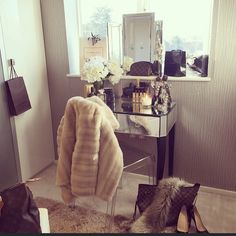 a dressing room with a mirror and some shoes on the floor