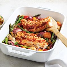 a white casserole dish filled with chicken and vegetables