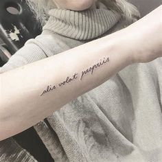 a woman with a tattoo on her arm that says, all we want is love