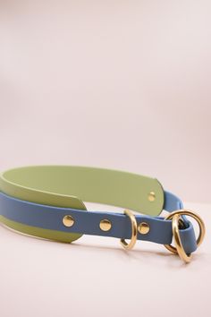 two different colored leather collars with gold rings