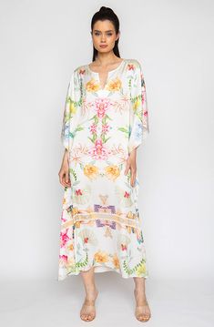 Bring out your inner flower in the Botanica Long Caftan. This gorgeous piece of apparel features delicate flowering patterns, giving you the freedom to show off your unique style. And the airy fabric won’t weigh you down, meaning you can wear your beauty around the clock! Bloom into something special with the Botanica Long Caftan. Printed short caftan Can be worn loose or cinched at the waist Comes with a matching belt as an option for styling Lusciously soft poly-silk blend for ease of care Mac White V-neck Floral Print Kaftan, Silk Kaftan With Floral Print And V-neck, Silk Floral Print Kaftan For Beach Cover-up, Elegant Floral Print Tunic Kaftan, Spring Floral Print V-neck Kaftan, Long Sleeve Silk Beach Dress, Elegant Floral Embroidered Kaftan For Spring, Spring Beach Cover-up Flowy Tunic, Bohemian Silk Kimono With Floral Print