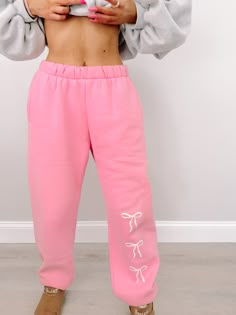 We are so excited to release our newest Sassy Shortcake merch item! The Blushing Bow Sassy Sweatpants are pink and feature three white bows text. These sweats feature an elastic waistband and pockets for maximum comfort, and feature a soft micro-fleece lining. Rep your favorite brand in these super cute pants!! Also available in blue and grey. fits: true to size, model wearing a size small content: 100% polyester care: hand wash cold Cute Pink Pants For Spring, Pink Sweatpants For Spring Loungewear, Pink Cotton Bottoms For Leisure, Pink Athleisure Bottoms With Elastic Waistband, Sporty Pink Sweatpants For Spring, Cute Pink Pants With Elastic Waistband, Pink Spring Sweatpants For Loungewear, Pink Sweatpants With Elastic Waistband For Loungewear, Cute Spring Loungewear Pants