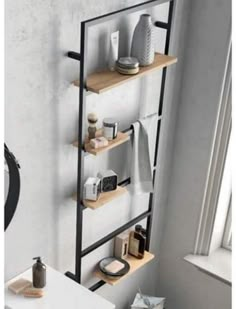 a bathroom with a toilet, sink and shelves on the wall next to a window