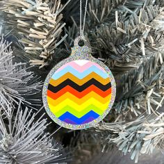 a colorful ornament hanging from a christmas tree