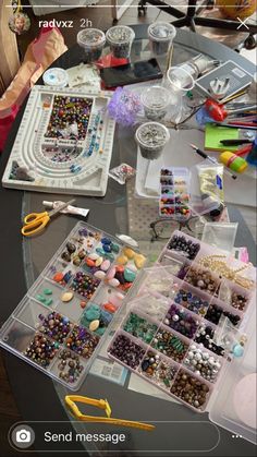 the table is covered with beads and other crafting supplies