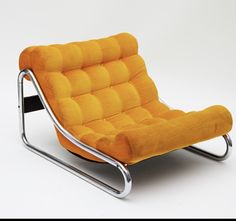 an orange chair sitting on top of a metal frame