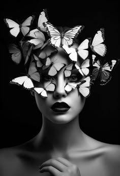 a woman with butterflies on her head and black lips, in the shape of butterfly wings