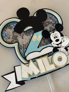 a mickey mouse birthday cake topper with the number one on it's face