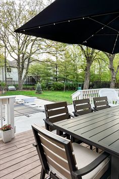 an outdoor table and chairs on a wooden deck