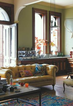 a living room filled with furniture and lots of windows