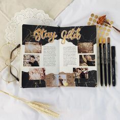 an open photobook with photos and pens on it next to some gold confetti