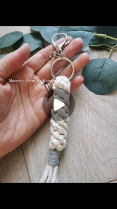 a hand holding a keychain that is made out of rope