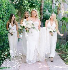 bridesmaids in white dresses walking down the path