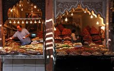 a man standing in front of a store filled with lots of food