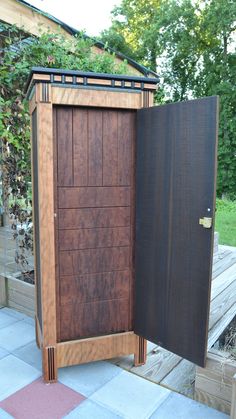 an open wooden cabinet sitting on top of a patio