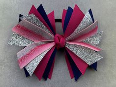 **Need more bows or hair ties than are showing available?  Just ask!  We love team orders and can usually make any number you need! For more team gifts, check out our other Etsy shop, TheRibbonLibrary.** We can make one of these sports bows for you, or we can make them for your whole team!  Countless color combinations available - just ask! First photo: a sample of the actual bow you will receive.  This is made-to-order, so your bow may have slight differences. Following photos: examples of how the bow can be worn, the approximate size, and what the back typically looks like. These photos are just examples.  The bow is secured to an elastic hair band to place in the hair. Foxy Ties prides itself on workmanship and quality.  Lauren uses extra care and time with each bow, choosing color comb Volleyball Bows, Soccer Bow, Dance Bows, Softball Bow, Bow Hair Tie, Glitter Ombre, Ombre Color, Elastic Hair Bands, Kansas City Mo