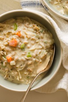 two bowls of chicken noodle soup on a table