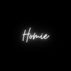 the word homie written in neon light on a black background with white writing underneath it