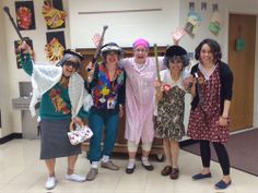 four women in costumes posing for a photo