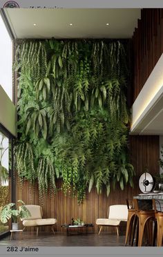 a living room with plants on the wall and chairs around tables in front of it