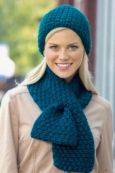 a woman wearing a blue knitted hat and scarf