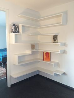 a corner book shelf in the corner of a room