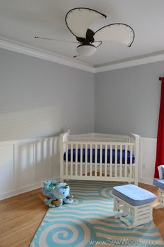 a baby's room with blue and white decor