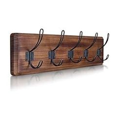 a wooden coat rack with four hooks on it