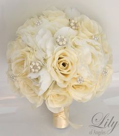 a bridal bouquet with white flowers and pearls