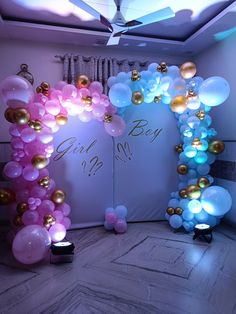 an arch made out of balloons with the word girl on it