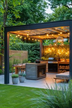 an outdoor kitchen and grill area is lit up by string lights, surrounded by greenery