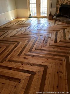 an empty room with wood flooring in it