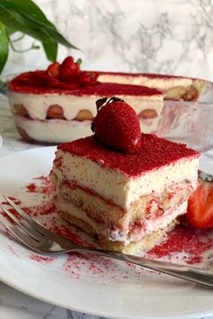 there is a piece of cake with strawberries on it and the rest of the cake has been eaten