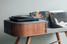 an old record player and vinyl records on a table