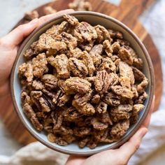 a person holding a bowl filled with nuts